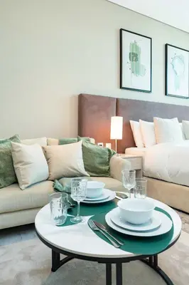 a living room with a coffee table and a couch at PVH - Seven Palm - Modern Studio with Beach Access near Palm Jumeirah Mall in Dubai