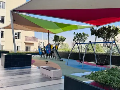 a playground with a canopy and slides and swings at Remraam Holiday Home Dubai in Dubai