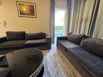 a living room with a couch and a table at Remraam Holiday Home Dubai in Dubai