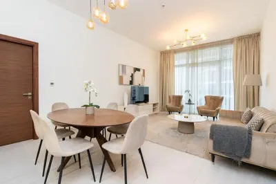 a living room with a table and chairs and a couch at CitiHome - Spacious 2BR - Park Gate Residences in Dubai