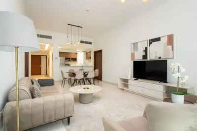 a living room with a couch and a tv at CitiHome - Spacious 2BR - Park Gate Residences in Dubai
