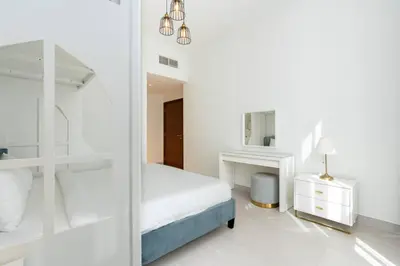 a white bedroom with a bed and a mirror at CitiHome - Spacious 2BR - Park Gate Residences in Dubai