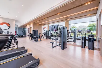 a gym with treadmills and elliptical machines at Vacationer l Vida T2 1 Bedroom l Direct Access to Dubai Mall in Dubai