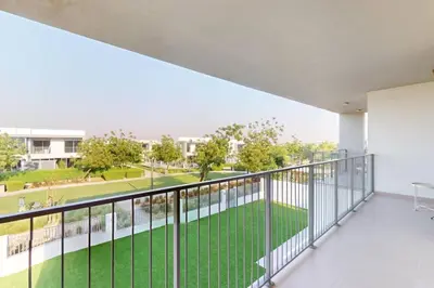 an apartment balcony with a view of a yard at Vacationer l Incredible 5 Bed l Private Garden l near Mall in Dubai