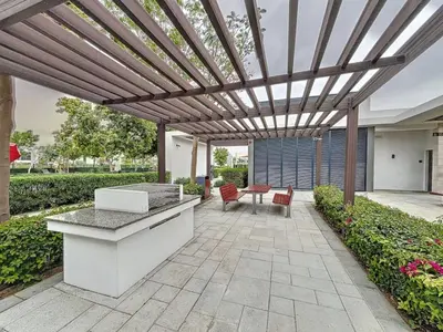 an outdoor patio with a wooden pergola at Vacationer l Incredible 5 Bed l Private Garden l near Mall in Dubai