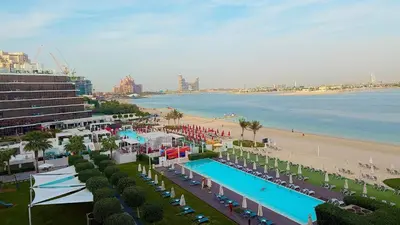 an aerial view of a beach and a swimming pool at Beachfront comfort your private escape at Palm jumeriah th8 residences in Dubai