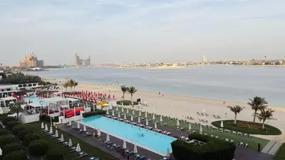 an aerial view of a beach and a swimming pool at Beachfront comfort your private escape at Palm jumeriah th8 residences in Dubai