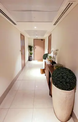 a hallway with plants in a building at Modern Deluxe Studio in Dubai in Dubai