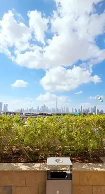 a park bench with a view of the city at Modern Deluxe Studio in Dubai in Dubai