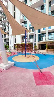 a playground in front of a building at Modern Deluxe Studio in Dubai in Dubai
