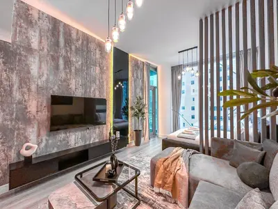 a living room with a couch and a fireplace at Marina Elegance, Walk to JBR Beach and Ain Dubai w Stunning Canal View in Dubai
