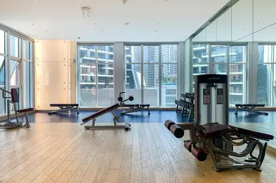 a gym with treadmills and machines in a building at Frank Porter - Damac Maison Prive in Dubai