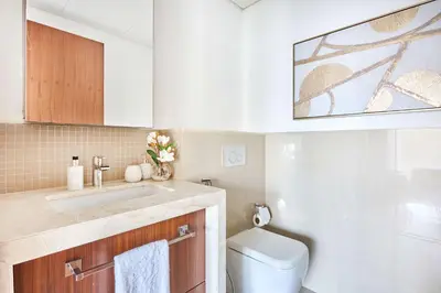 a bathroom with a sink and a toilet at Frank Porter - Boulevard Point in Dubai