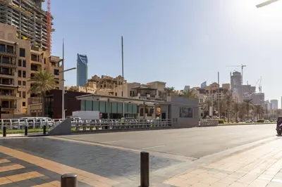 a street with a parking lot in a city at Frank Porter - Boulevard Point in Dubai