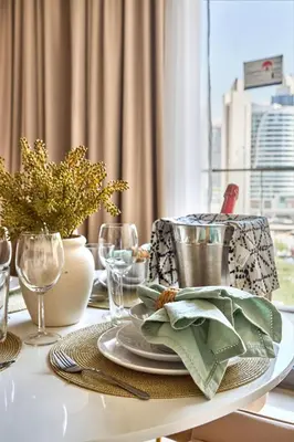 a dining room table with a plate of food on it at Frank Porter - Boulevard Point in Dubai