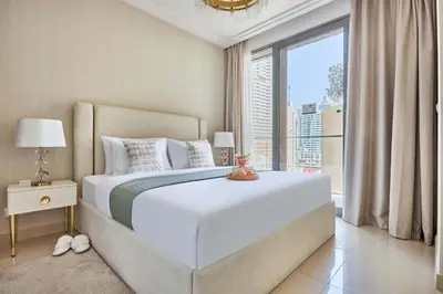 a bedroom with a large bed and a large window at Frank Porter - Boulevard Point in Dubai