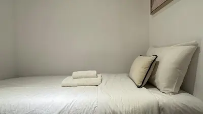 a white bed with two pillows on top of it at Stylish 2 Bed with full marina view on high floor in Dubai