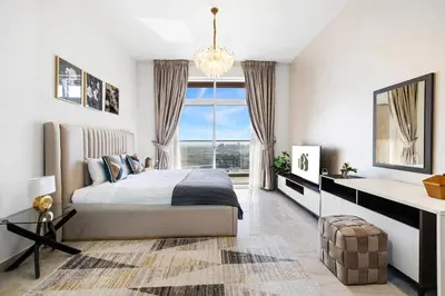 a bedroom with a bed and a large window at BLVD Modern Stay in Jewelz -Balcony Pool & Gym in Dubai