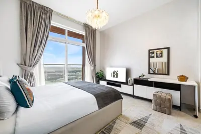 a bedroom with a large bed and a large window at BLVD Modern Stay in Jewelz -Balcony Pool & Gym in Dubai