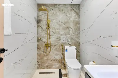a bathroom with a toilet and a shower at bnbmehomes - Skyz by Danube in Dubai