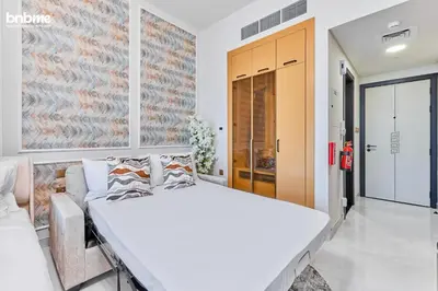 a bedroom with a large white bed in a room at bnbmehomes - Skyz by Danube in Dubai
