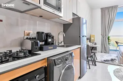 a kitchen with a sink and a stove top oven at bnbmehomes - Skyz by Danube in Dubai