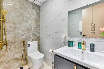 a bathroom with a white sink and a toilet at bnbmehomes - Skyz by Danube in Dubai