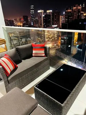 a balcony with a couch and a view of a city at Modern 2BR I DAMAC Reva Residences I Canal Views in Dubai