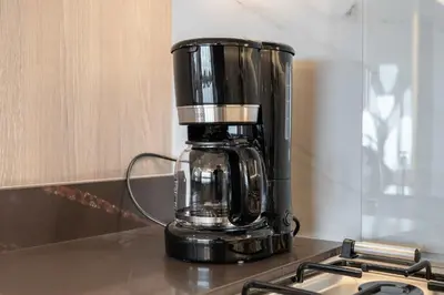 a black coffee maker sitting on top of a counter at Spacious 3BR and Study with Multiple Ensuites Medore Residence in Dubai