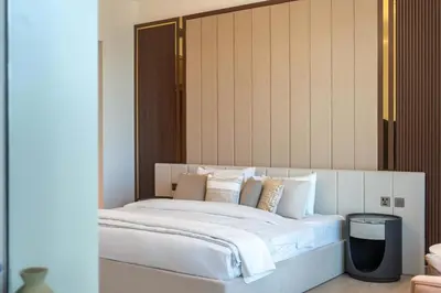 a bedroom with a bed with white sheets and pillows at Spacious 3BR and Study with Multiple Ensuites Medore Residence in Dubai