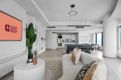 a living room with a couch and a pool table at GuestReady - 3BR | Luxury High-Rise Escape in Dubai