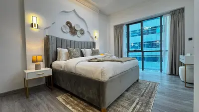 a bedroom with a large bed and a large window at 4BDR Duplex Apartment 8 Guests in Dubai