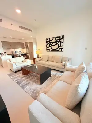 a living room with couches and a coffee table at Oshima Grande Downtown 1BR Burj Khalifa in Dubai