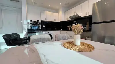 a kitchen with a table with a vase of flowers on it at 1 Bedroom centrally located with large balcony in Dubai
