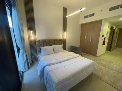 a bedroom with a large white bed in a room at Quiet Studio in Azizi 18-Ideal for Work & Leisure in Dubai