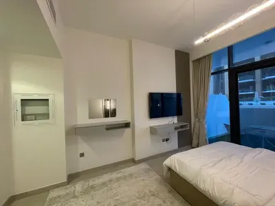 a bedroom with a bed and a flat screen tv at Quiet Studio in Azizi 18-Ideal for Work & Leisure in Dubai