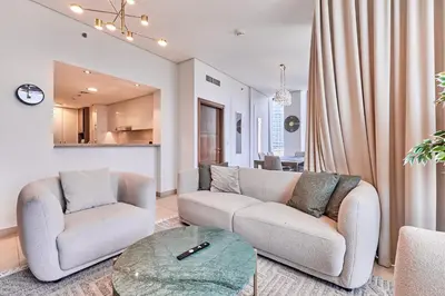 a living room with two couches and a table at Luxury Apartments Near Burj Khalifa in Downtown in Dubai