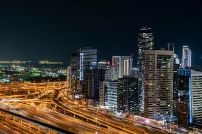 a city lit up at night with traffic at Luxury Apartments Near Burj Khalifa in Downtown in Dubai