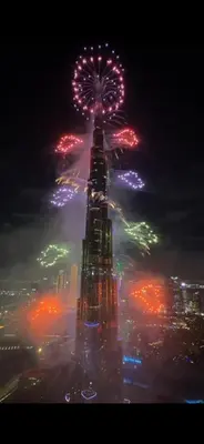 a large ferris wheel in a city at night at Luxury Apartments Near Burj Khalifa in Downtown in Dubai