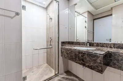 a bathroom with a sink and a shower at HAVN - Studio in Botanica, JVC in Dubai