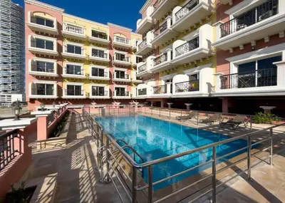 a swimming pool in the middle of a building at HAVN - Studio in Botanica, JVC in Dubai