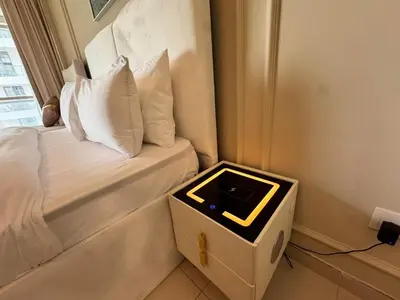a room with a bed with a box on it at Skylux Bright 1BR with Canal Views & Extra Bed in Dubai