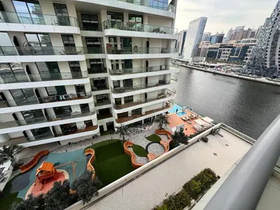 an aerial view of a large apartment building with a body of water at Skylux Bright 1BR with Canal Views & Extra Bed in Dubai