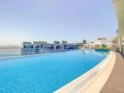 a swimming pool on the roof of a building at Splendid studio on the Palm, infinity pool & private beach in Dubai