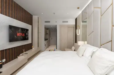 a bedroom with a large white bed in a room at Splendid studio on the Palm, infinity pool & private beach in Dubai