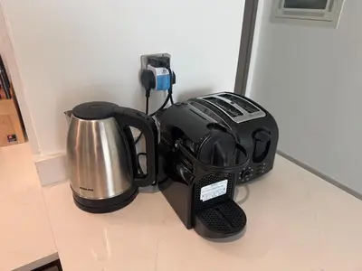 a kitchen counter with a coffee maker and a toaster at Harmonizing apartment 1BR with a balcony in Grande in Dubai