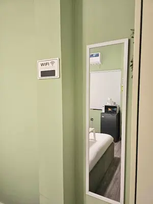 a mirror in the corner of a room with a bedroom at Green Zen Studio Metro 15 mins walk away in Dubai