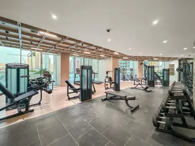 a gym with treadmills and exercise equipment in a building at Luxe 1BR in JVC with Private Jacuzzi & Pool Access in Dubai