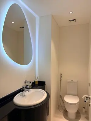a bathroom with a sink and a toilet with a mirror at Lovely beach life 1 bed apartment in Dubai Marina in Dubai