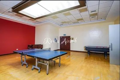 a ping pong room with a ping pong table in it at Lovely beach life 1 bed apartment in Dubai Marina in Dubai